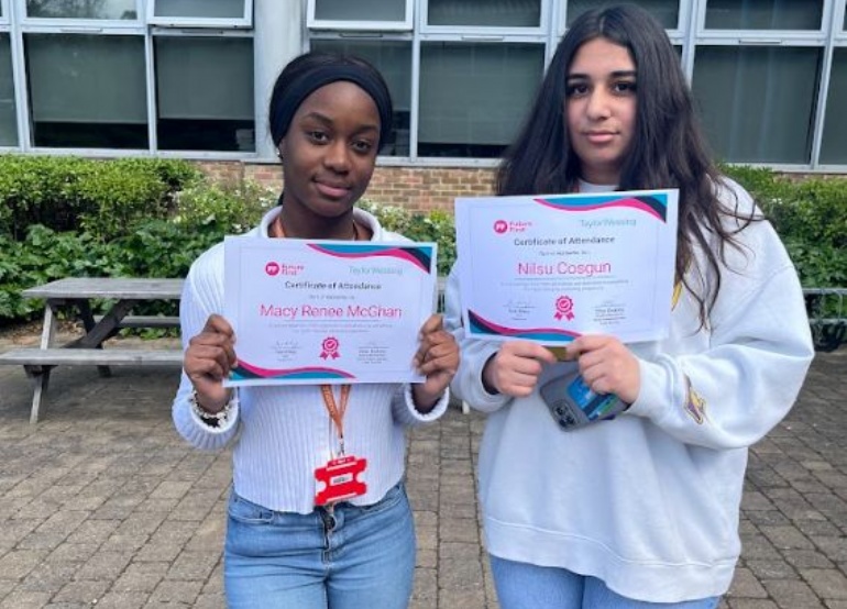 Students holding up certificates